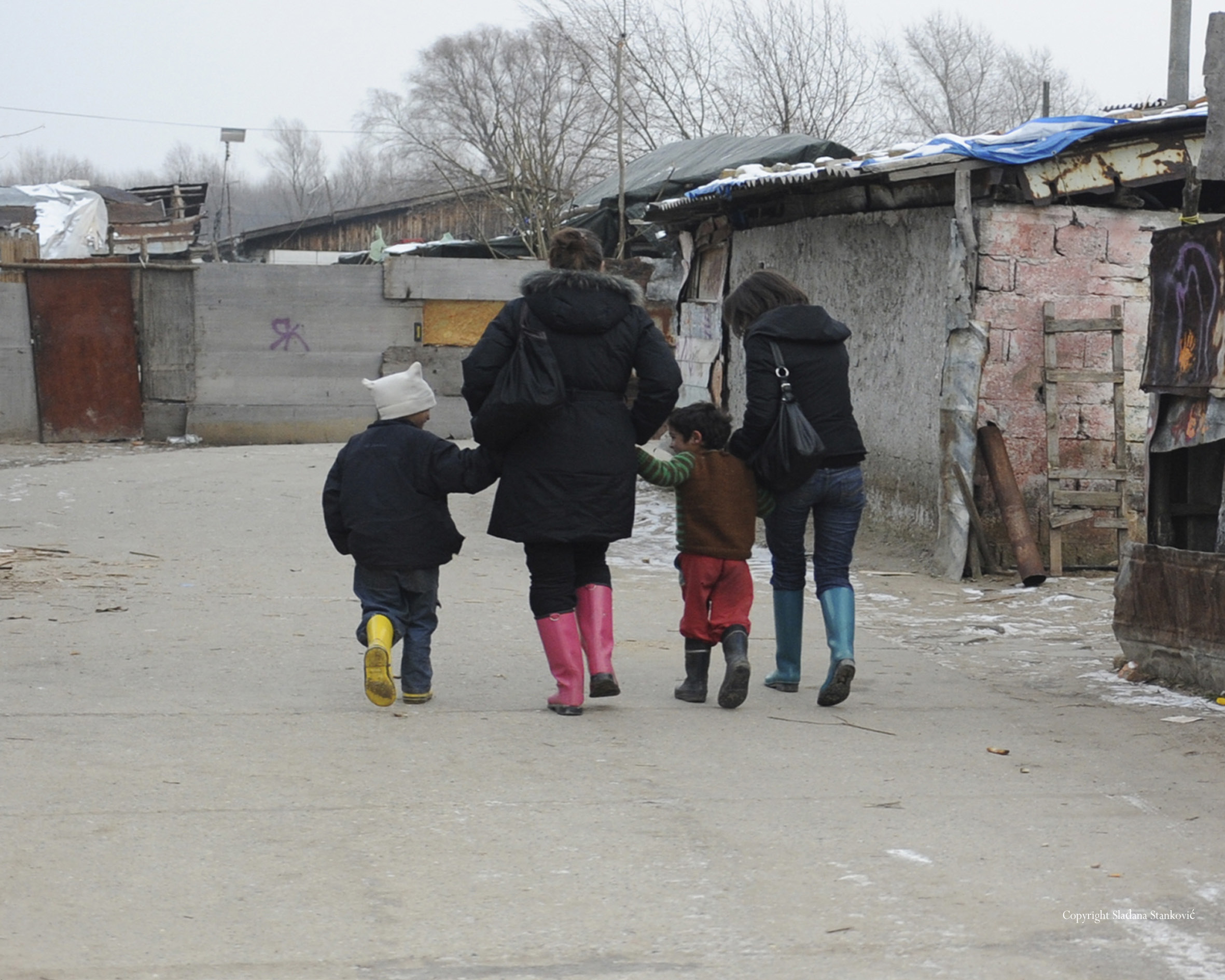 people walking through the roma setttlement